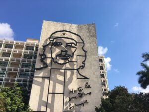 The "Scenic & Cultivated" features a large metal outline of Che Guevara's face on a government building set against trees and a blue sky. | Cubaecology